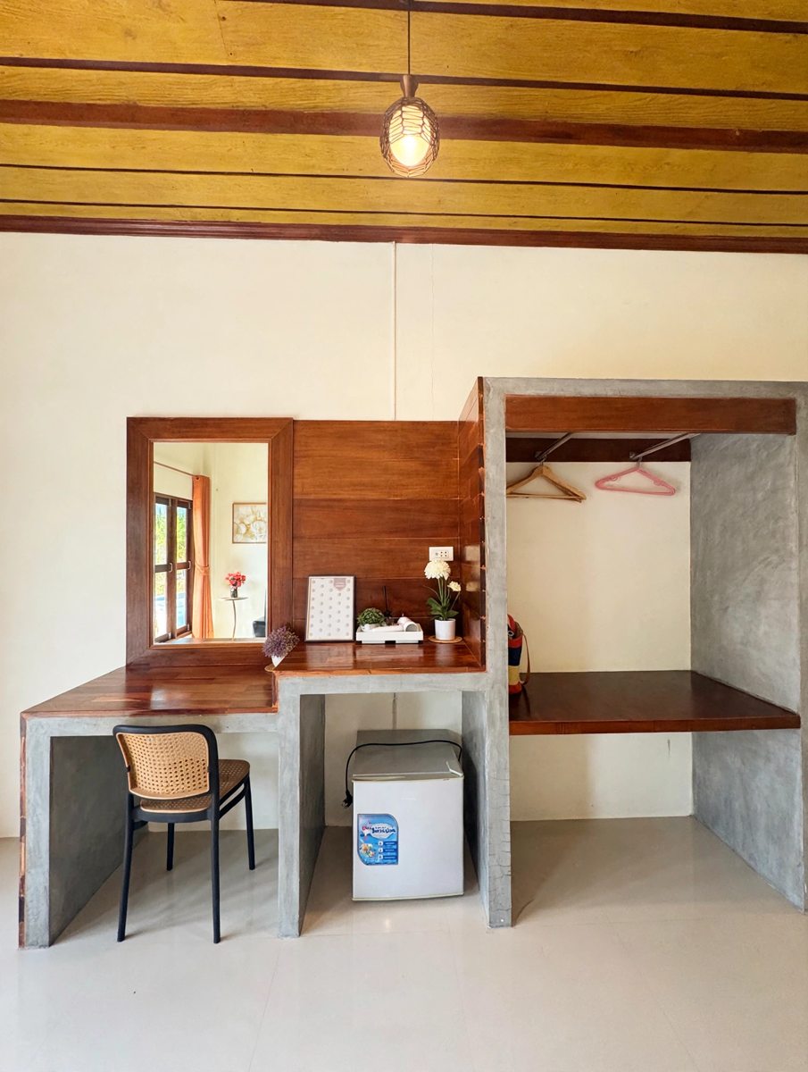 Room desk, mini fridge and open wardrobe